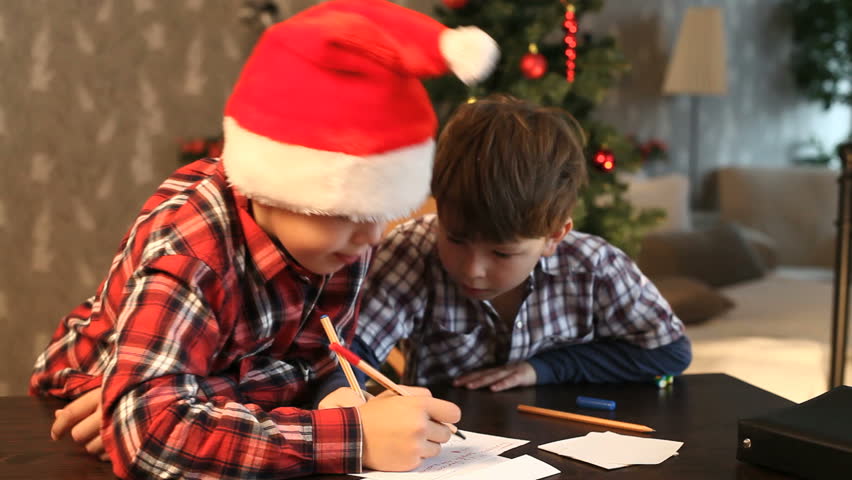 Two boys writing a letter to Santa Claus