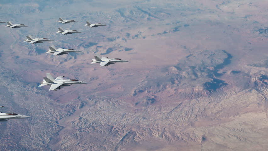 A squadron of F18 fighter jets flying in a four-finger formation ready to attack.  