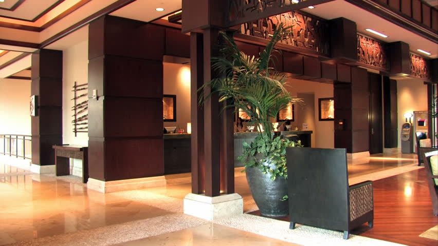 Hotel and luxury resort on shore of Maui, Hawaii. Inside pan right through lobby and entrance area. Fancy and upscale wealthy vacation destination.