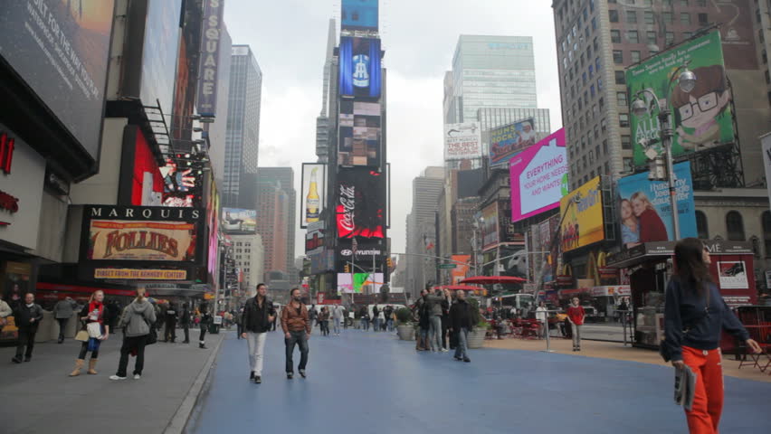 TIMES SQUARE, NEW YORK, NEW YORK - NOVEMBER 10 2011 -  Tourists in New York's Times Square see the signs and sights on a fall morning in November, 2011.