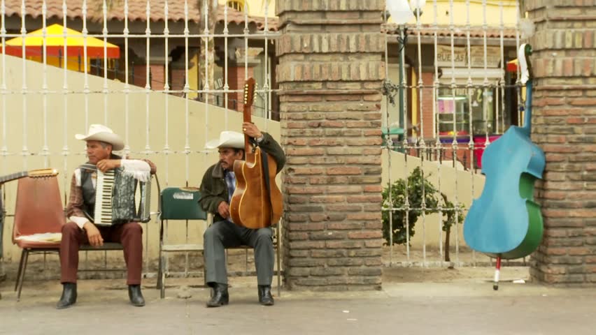 U.S./MEXICO BORDER - CIRCA 2008: Musicians chat in downtown Tijuana Mexico.