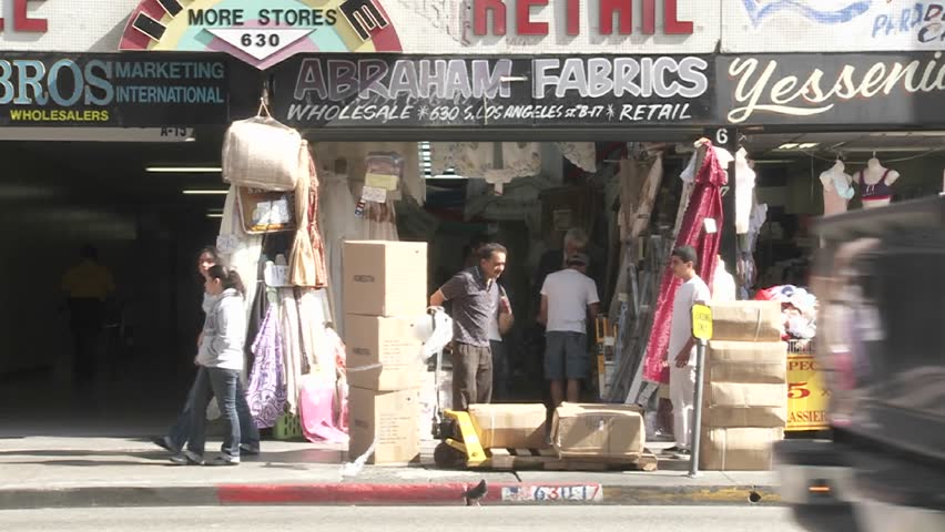 LOS ANGELES - CIRCA 2008: Store vendors unload stock in front of their store in Downtown Los Angeles California.