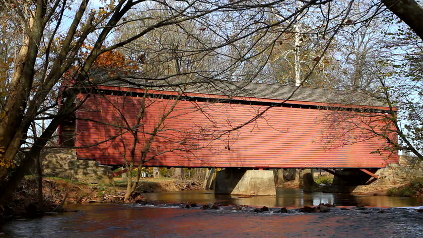 Vintage wooden covered bridge spans Owens Creek in Frederick County, Maryland.