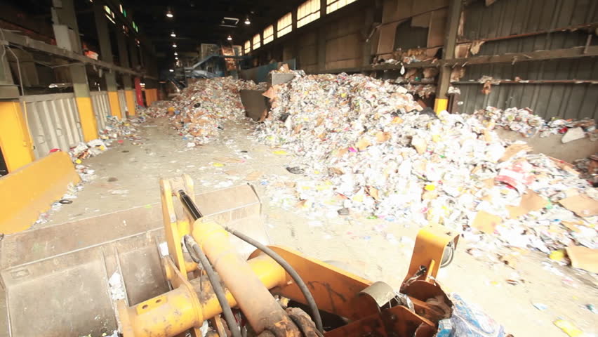 a bulldozer hauling garbage