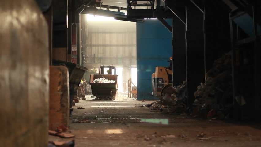a bulldozer hauling garbage