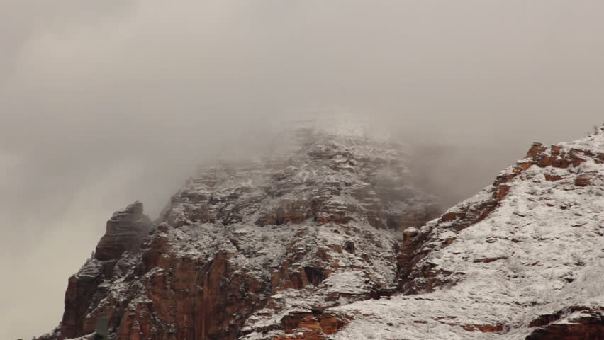 Clouds move quickly over the high-altitude red rocks in Sedona, Arizona after the first big snow of the season. Shot Nov 5, 2011.