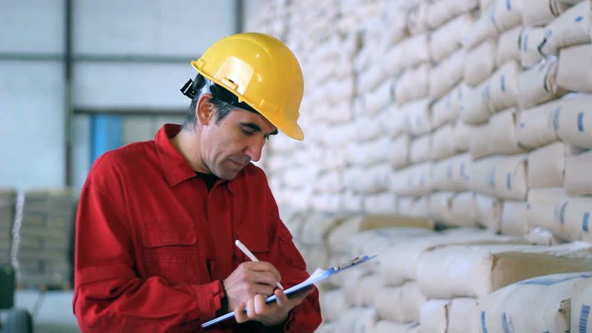 Warehouse worker with clipboard checking inventory. HD 1080i .