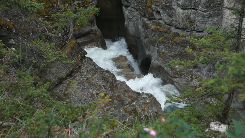 River gorge and powerful river waterfall at Maligne Canyon, Jasper National Park, Alberta, Canada. Rushing water pours through narrow gorge