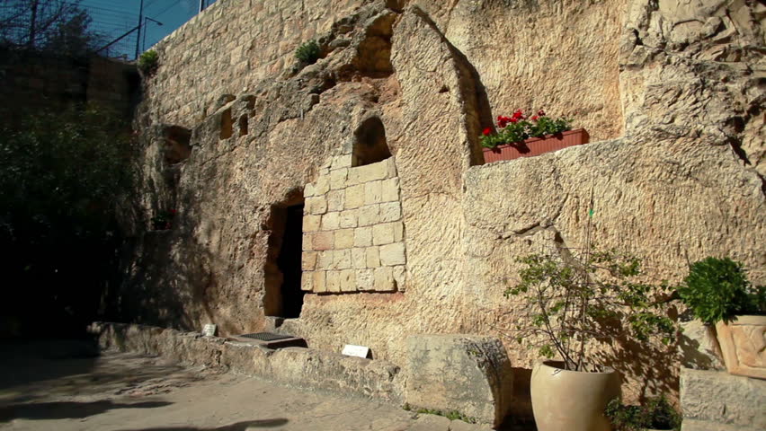 Two tourists, a man and a woman, going into the Garden Tomb in Jerusalem, Israel, one of the speculated tombs where Jesus was buried.