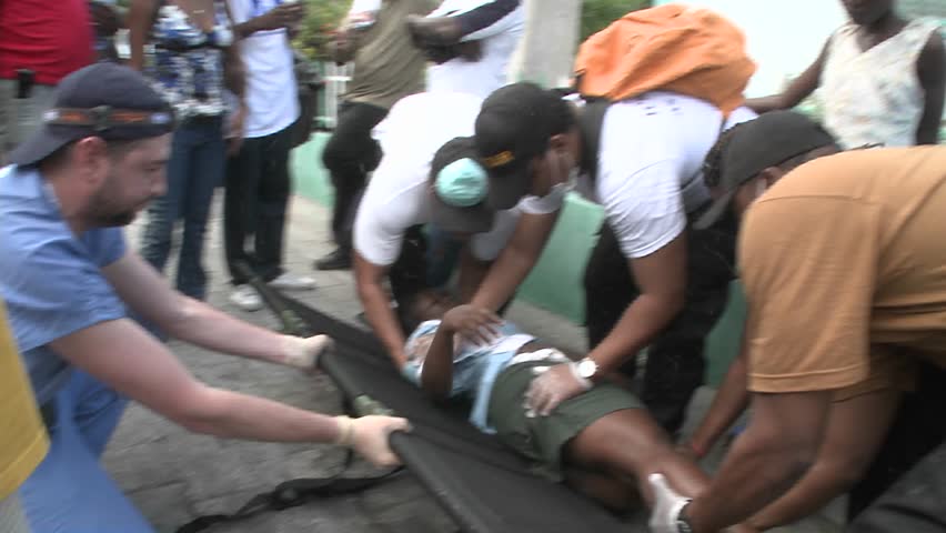 PORT-AU PRINCE, HAITI - CIRCA 2010: people carrying an injured person circa 2010 in Haiti.