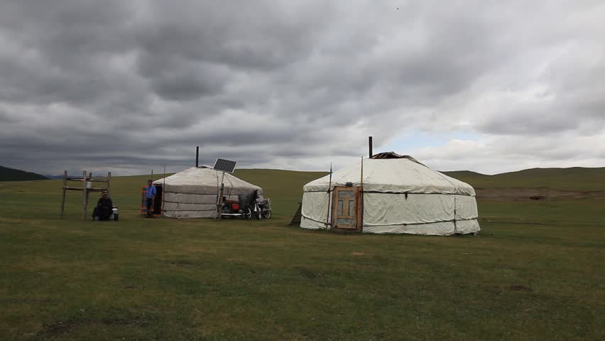 MONGOLIA - JULY 14, 2009: Two men stand next to huts on the plains on July 14, 2009 in Mongolia.