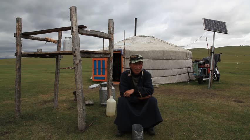 MONGOLIA - JULY 14, 2009: A man sits in front of a hut on the plains on July 14, 2009 in Mongolia.