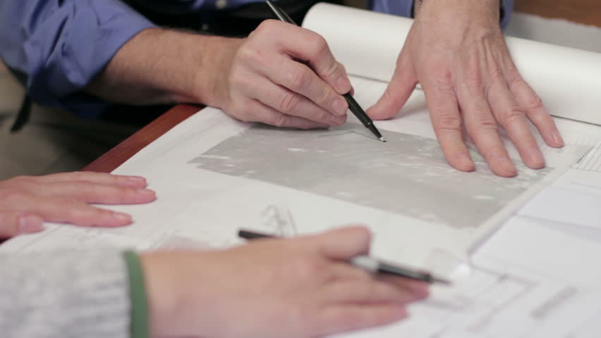 Architects sketching plans, close up on hands