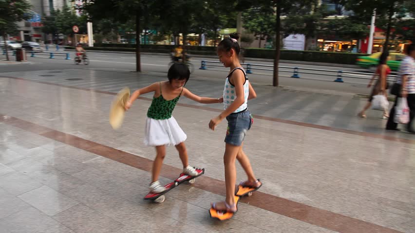 CHENGDU, CHINA - JULY 24, 2009: Young children ride skateboards in circles on July 24, 2009 in Chengdu.