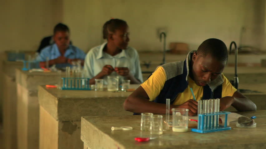 KENYA, AFRICA - CIRCA 2011: School boy doing chemistry in Kenya, Africa.