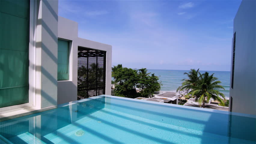 Swimming pool of a luxury villa. Tracking shot.