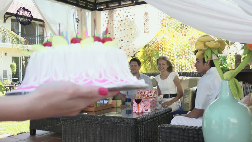 Birthday party with cake, drinks and happy friends taking pictures