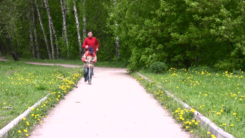 father with son on scooter