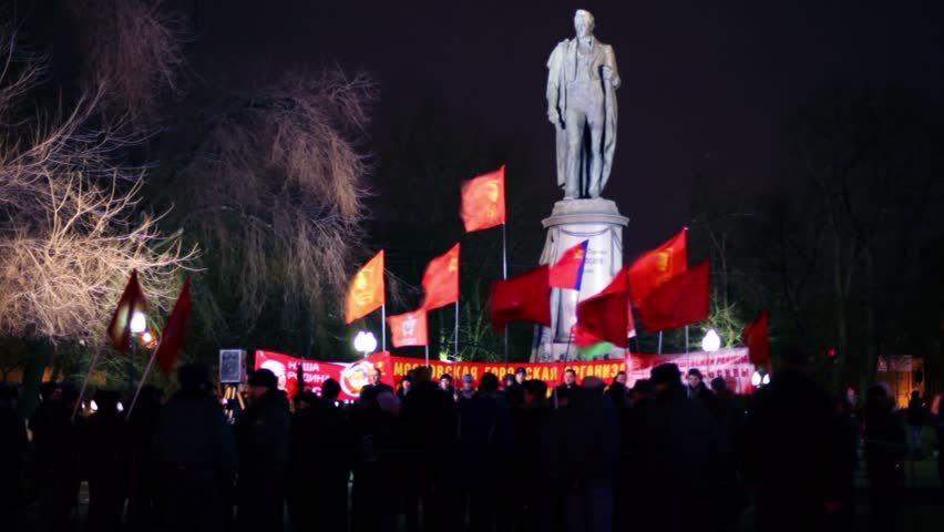 MOSCOW - MARCH 17: Lot of communists stand with flag in front of monument at approved meeting near metro station Chistiye Prudy on March 17, 2011 in Moscow, Russia.