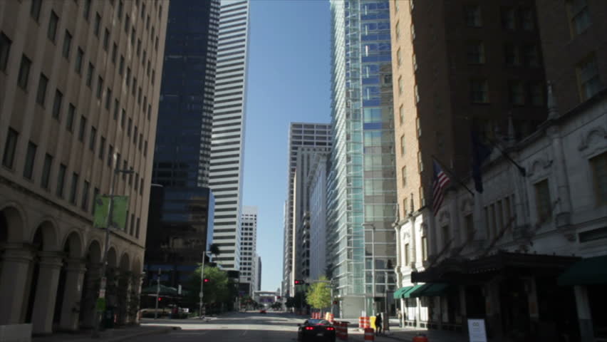 A skyward perspective of the skyscrapers in downtown Houston Texas when driving through the city.