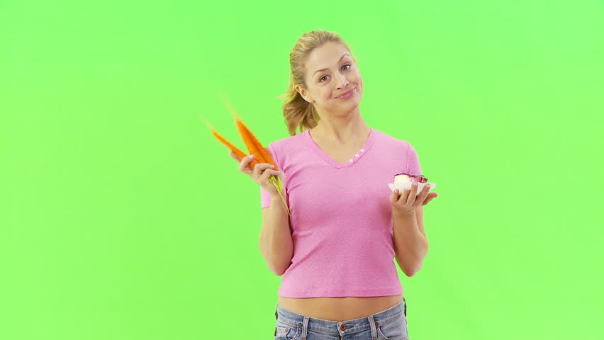 Woman deciding between carrots and cake