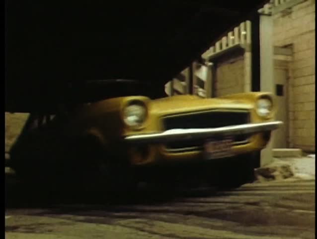 Car speeding on roof level of parking garage