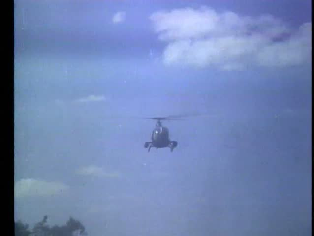 Helicopter firing missile into grove