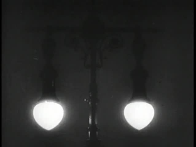 Close- up of 1930s street lamp lit up at night