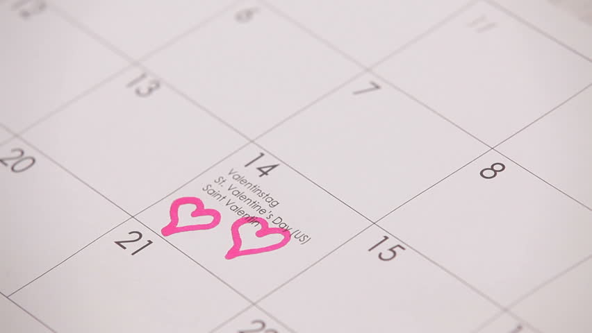 Two hearts in the calendar. HD. The woman draws two hearts on the calendar.Valentine's Day theme. theme. close up.