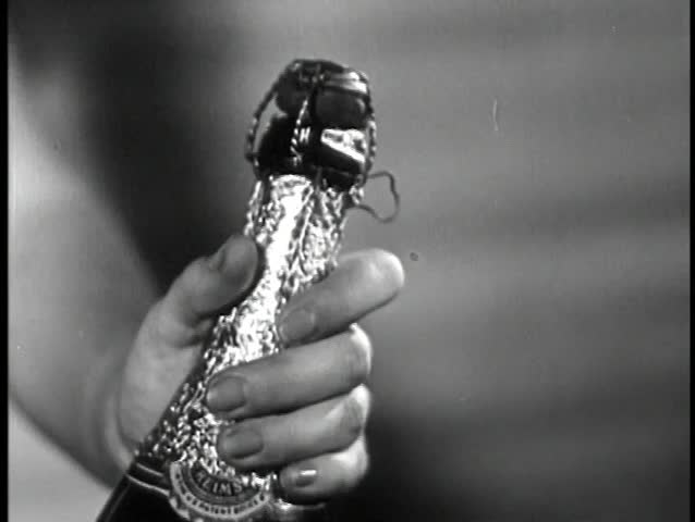 Close-up of cork popping off champagne bottle
