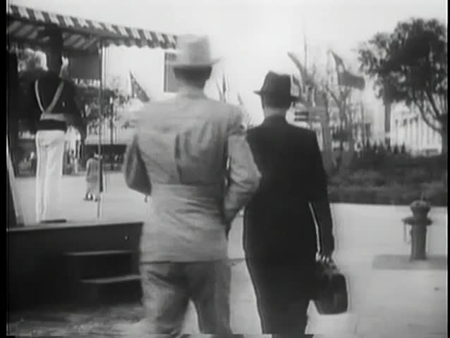 Rear view of men hurrying down street