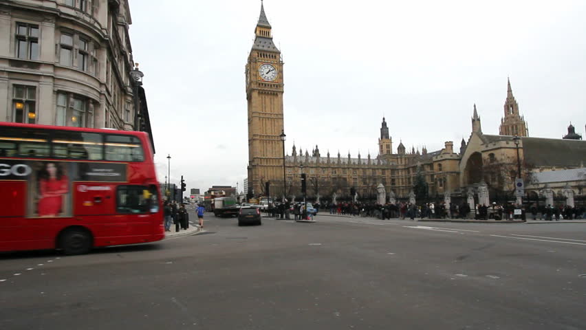 LONDON, UK - DECEMBER 27: Public bus and other traffic drives past Big Ben in London on December 27, 2011. Big Ben is the clock tower of Westminster Parliament.