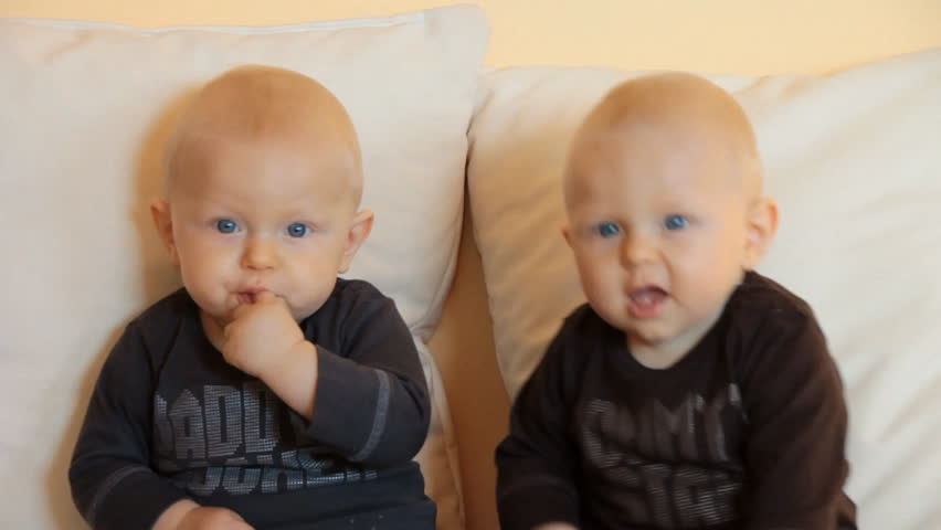 6 months twins sit on couch
