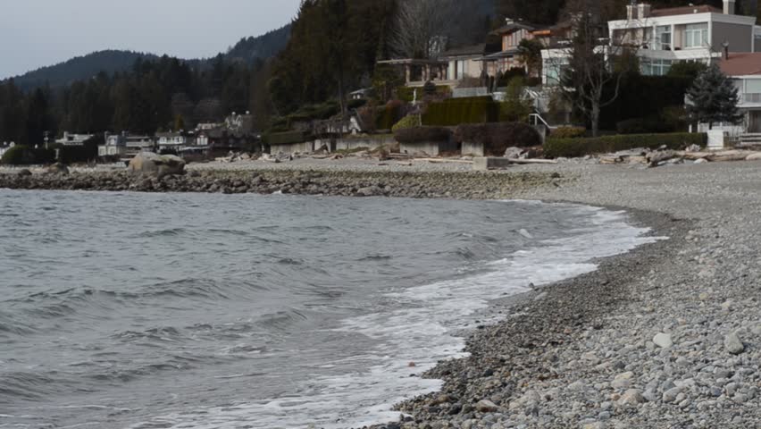 grey and gloomy west coast ocean beach at winter in Vancouver, Canada.