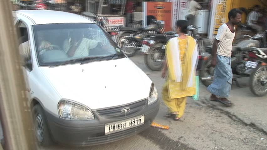JALANDHAR, INDIA - AUGUST 20, 2006: Street traffic ambiance of  crowds, cows and vehicles