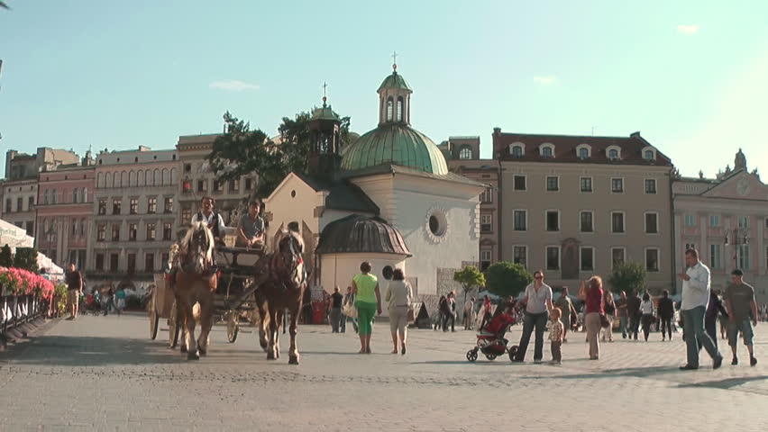 KRAKOW, POLAND - CIRCA 2011: Tourists take city tour on horse-drawn carriage.
