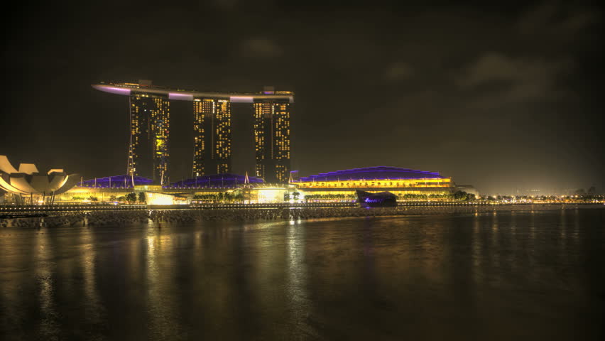 Timelapse Singapore Marina Bay at night with a view of the Opera and Skyscrapers at night  zoom-in