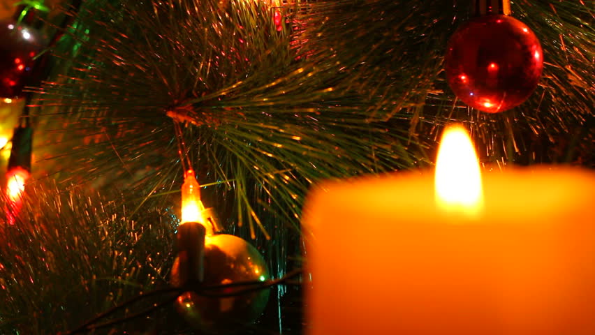 burning candle on the background of the Christmas tree