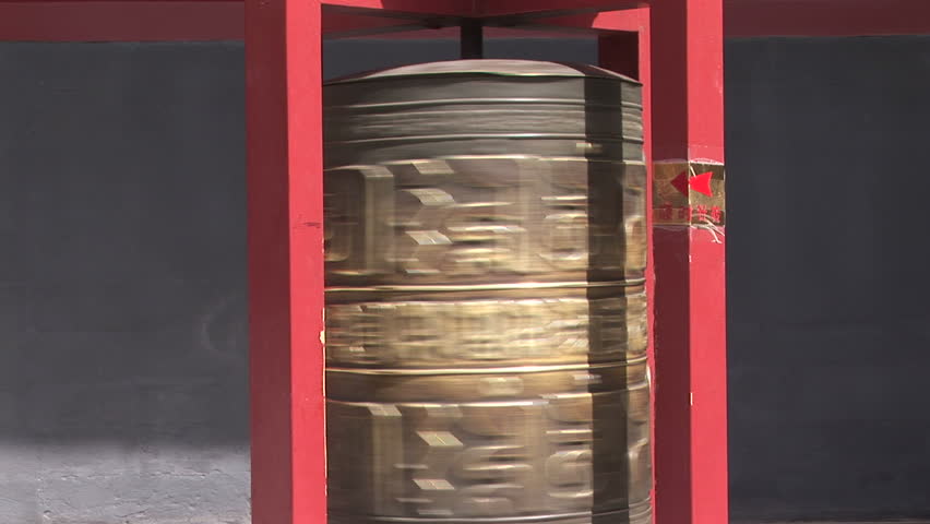 Bronze prayer wheel rotating in the Lama Temple, Beijing, China