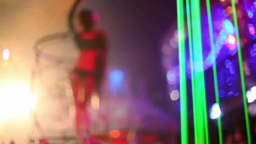 Almost nude woman dance in night club, unfocused view