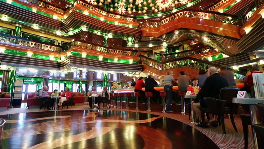 MEDITERRANEAN SEA - MARCH 16: Unidentified passengers of the Costa Concordia cruise ship relaxing at the elegant lobby bar, 16 March 2011. The Costa Concordia cruise ship ran aground and sank on January 16, 2012.