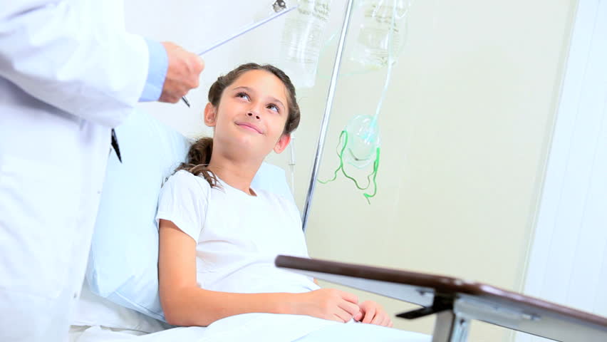 Young caucasian girl attended by doctor and nurse in hospital clinic