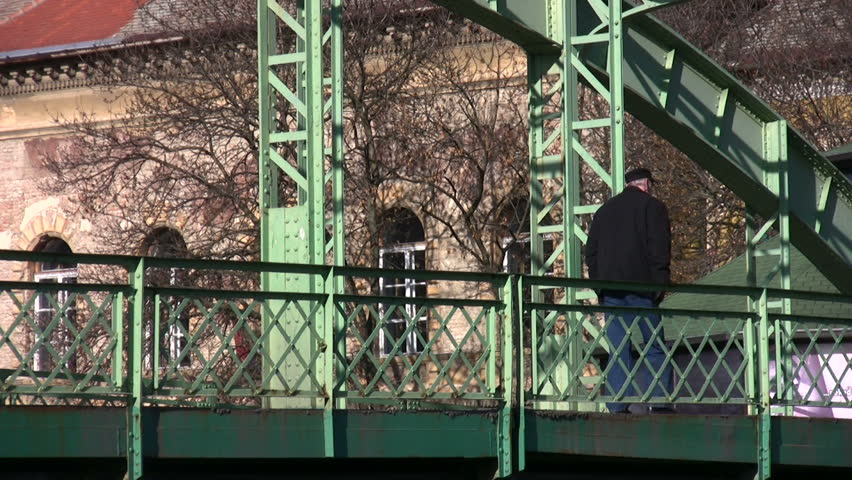Senior man crossing the bridge alone