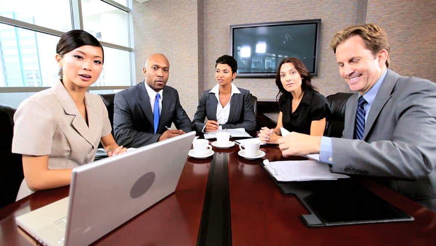 Multi ethnic executive team using a video link for a business presentation