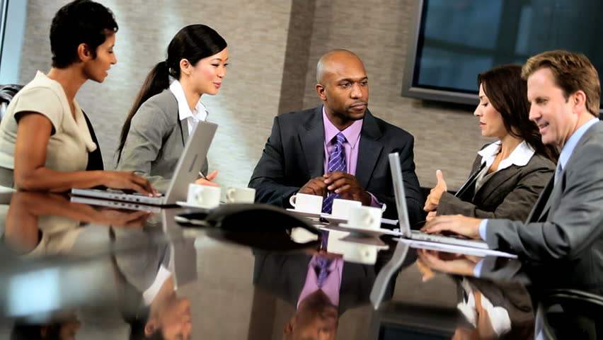 Male african american executive with his multi ethnic business team in the boardroom
