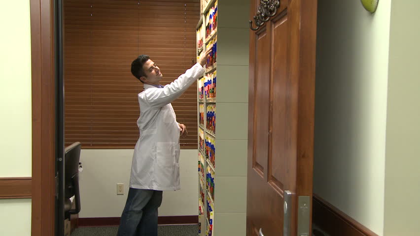 Nurse helps doctor find medical chart