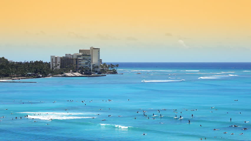 High view at the beach resort in Waikiki, Hawaii. Lots of people surfing, swimming and enjoying the water.-