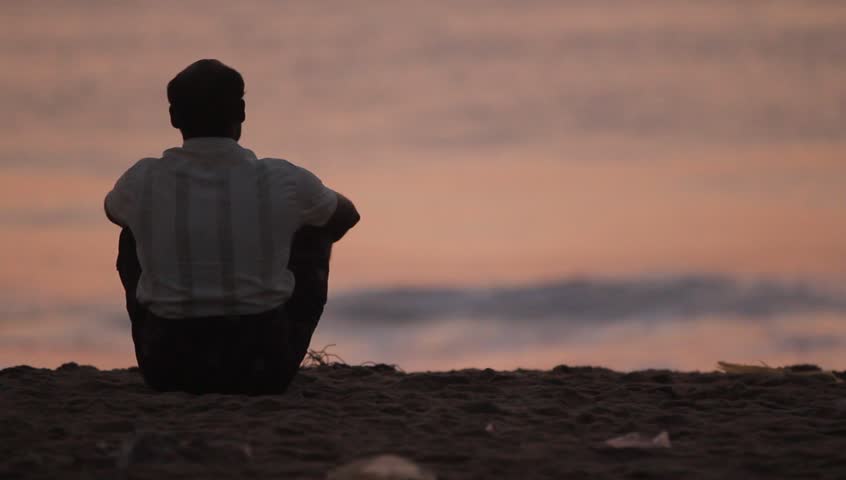 Man relaxing behind the sea shore.