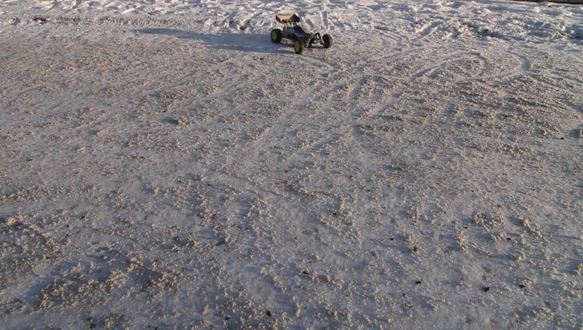 RC buggy car driving on snowy road