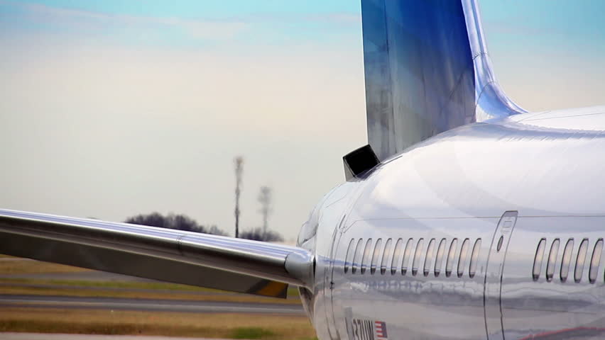 The exhaust from a jet sitting at an airport gate.
